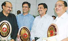 Awardees of three small-scale industrial units with their trophies with the UT Home Secretary-cum-Secretary, Industries, in Chandigarh
