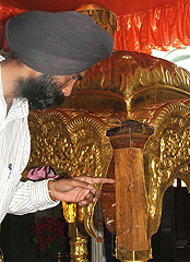 A devotee showing the missing part of gold at Punjabi Bagh Gurdwara in the Capital on Thursday
