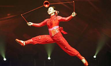 A Chinese acrobatic performer twirls an object on a thread as part of a show by an acrobatic troupe from Guang Zhou province in Bangkok on Thursday