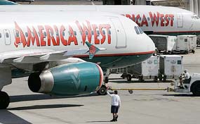 American West grounds crew direct planes as they arrive and depart from Phoenix Sky Harbor International Airport on Thursday. US Airways Group Inc. and America West Holdings Corp, the nations seventh and eighth largest carriers, announced merger plans on Friday to create what they said would be the nations first full-service, low-fare airline.