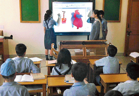A student of The Gurukul, Panchkula, uses the Smart Board in their classroom.