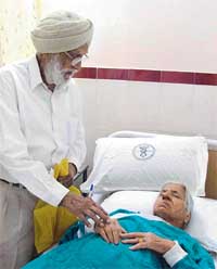 Mrs Bhagwant Kaur being attended to by her husband, Mr Baldev Singh, at SAS Grewal Hospital in Ludhiana after she was injured while trying to resist two purse snatchers in Gurdev Nagar on Friday