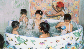 Students of Sai Grace Public School, Said Pura, Dera Bassi, have a dip in splash pool on the school campus on Saturday.