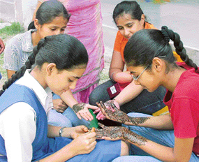 Students of Gem Public School participate in a mehndi competition in Mohali on Saturday.