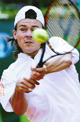 Guillermo Coria of Argentina hits a backhand shot to Florian Mayer of Germany during their match at the World Team Cup final in Dusseldorf on Saturday