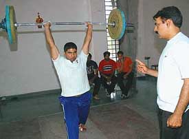 A young lifter undergoes training at the Sector 42 training centre