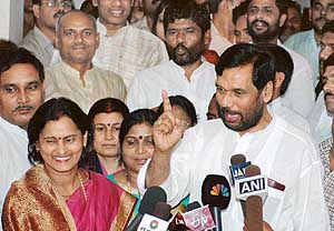 Lok Janshakti Party chief and Union Minister for Chemicals and Fertilisers and Steel Ram Vilas Paswan with his party MLA talks to the media  at his residence in New Delhi on Sunday.