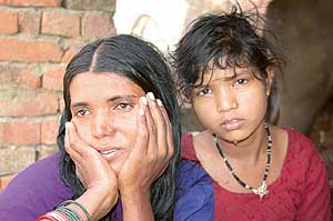 Geeta sobs for her 11-year-old daughter who was deserted by her husband at Dhand village in Kaithal on Sunday.