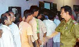 Voters stand in the queue at a polling booth for the municipal elections at Titagarh in Kolkata on Sunday.