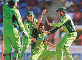 Pakistans Rao Iftikhar Anjum celebrates with team-mates after running out West Indies captain Shivnarine Chanderpaul during the second one-day international in Gros Islet, St Lucia