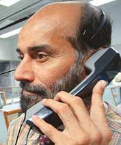 A Pakistani stockbroker speaks on the telephone at the Karachi Stock Exchange on Monday.