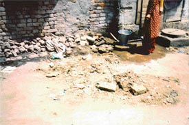 A resident of Labour Colony, near Industrial Area, fetches water from a tap surrounded by stagnated water, heaps of garbage, overflowing gutter and public toilets