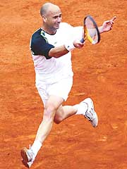 Andre Agassi of the USA runs to return the ball to Jarkko Nieminen of Finland during their match in the first round of the French Open at Roland Garros on Tuesday