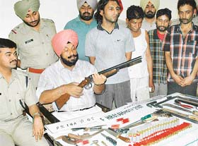 The SSP (Ropar), Mr S.P. Singh, shows the cache of arms and ammunition seized from the gang of burglars in Kharar