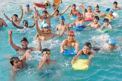 Summers are cool for children splashing about in cold waters during a summer camp in Jalandhar. 