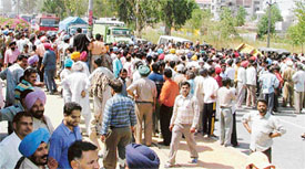 Protesters block National Highway No. 1, near Jalandhar bypass, in protest against the murder of a youth in broad daylight, in Ludhiana on Friday