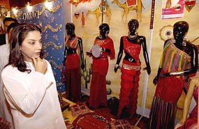 Bollywood actress, social worker and Rajya Sabha MP Shabana Azmi looks at the designer's collection created by students of J.D.Institute of Fashion Technology in New Delhi on Sunday.