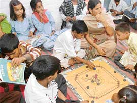 Adolescents play carrom and read books at the Yuva Josh Adolescent Health Centre at a slum in Panchkula. 