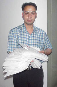 Deepak Sharma of Ludhiana holding the 1410-page-long bill that he got for sending 1,82,689 SMS in one month