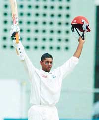 Shivnarine Chanderpaul celebrates after scoring a century against Pakistan on the third day of the first Test at the Kensington Oval in Bridgetown on Saturday. 