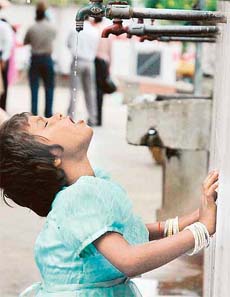 A child quenching thirst from a low-pressure tap in Chandigarh