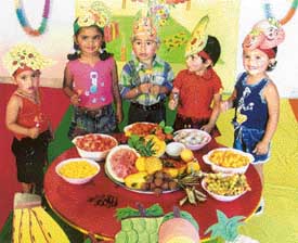 Students of Chanda Mama School enjoy fruit party organised on the school premises on Monday