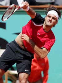 Roger Federer of Switzerland returns the ball to Victor Hanescu of Romania during their quarterfinal match in the French Open at Roland Garros on Tuesday