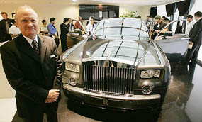 Colin Kelly, Rolls-Royce Regional Director, Asia-Pacific, poses next to a new extended wheelbase Rolls-Royce Phantom car at the companys showroom in Hong Kong on Wednesday. The car is designed to appeal to Asias tycoons who have HK $ 6.4 million ($ 3,85,000) to splash out on a new vehicle.