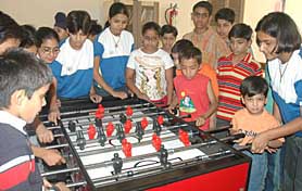 Children play table soccer in the Chandigarh Press Club on Wednesday.