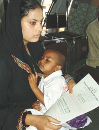 A woman with her child taking it easy after collecting a form for Haj Yatra 2006 at Haj Committee of India Office in the Capital on Wednesday.