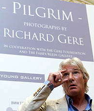 Hollywood actor Richard Gere adjusts his glasses during a news conference on his photo exhibition about Tibetan culture in Brussels, Belgium, on Wednesday