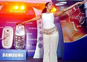 A dancer gestures during the launch of new Samsung mobile phones, in Bangalore on Thursday. Samsung launched two new mobile phones, SGH C230 and SGH X640.