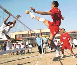 A Manipur player kicks the ball across the net during the 16th Senior National Sepak Takraw Championship being held at St Josephs Senior Secondary School, Sector 44, Chandigarh, on Thursday.