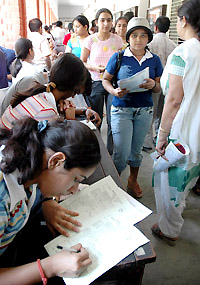 A picture of concentration: Students filling up forms as the admission process gets under way at Delhi University on Thursday. 