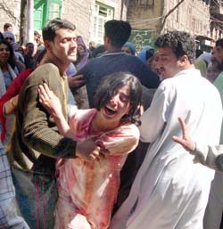 Daughter of Muhammad Ashraf Balla, member of the Srinagar Municipal Corporation, wails after his father was killed by militants at Khanyar on Friday.