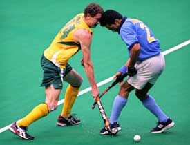 Australias Travis Brooks fights for the ball with Indias Jasvinder Singh during a match at the 14th Sultan Azlan Shah Cup Hockey Tournament in Kuala Lumpur on Friday