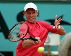 Russias Nikolay Davydenko plays a shot to Argentinas Mariano Puerta during their semifinal at the French Open in Paris