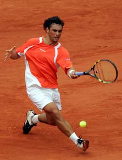 Argentinas Mariano Puerta hits a forehand to Russias Nikolay Davydenko during their semifinal at the French Open in Paris on Friday