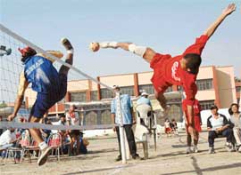 Manipur and Assam players struggle to topple each other during the XVIth Senior National Sepak Takraw Championship, being held at St Joseph Senior Secondary School, Sector 44, Chandigarh, on Saturday. 
