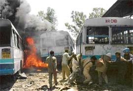 Employees of the Haryana Roadways pull a bus away from fire at their depot in Industrial Area, Phase I, Chandigarh, on Saturday.