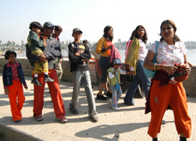 Tourists stroll on the boulevard of Dal Lake in Srinagar on Saturday