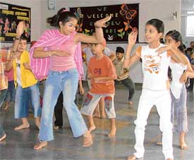Children perform at the conclusion of a summer camp at Sat Paul Mittal School