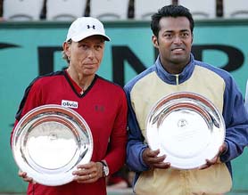 Indias Leander Paes and the USAs Martina Navratilova with the runners-up trophy after losing the French Open mixed double final against Frances Fabrice Santoro and Slovak Republics Daniela Hantuchova in Paris on Friday. Santoro and Hantuchova won 3-6, 6-3, 6-2