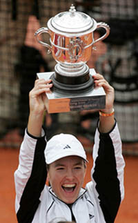 Justine Henin-Hardenne holds the cup after winning her women's final match
