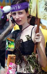 Christina Mac Farquhar from Scotland displays an outfit decorated with recyclable items and grass during a rally to celebrate World Environment Day in Taipei (Taiwan) on Sunday.