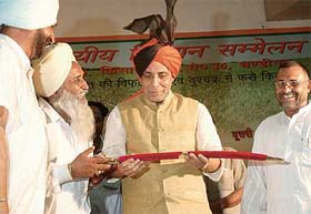 BJP workers present a sword to Mr Rajnath Singh, former Union Minister of Agriculture, at the inter-state Kisan Sammellan being held in Chandigarh