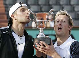 Swedens Jonas Bjorkman and Belarus Max Mirnyi hold the trophy after defeating the USAs Mike Bryan and Bob Bryan in the mens doubles final at the French Open in Paris on Saturday