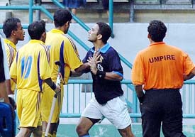 Deepak Thakur and Jiwa Mohan of Malaysia  have an altercation as Malaysian skipper S. Kuhan tries to calm them during the playoff for the fifth place at the 14th Sultan Azlan Shah Cup in Kuala Lumpur on Sunday