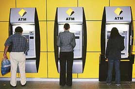 Commonwealth Bank customers use automatic teller machines (ATMs) in Sydney on Monday as the Reserve Bank of India announced the approval for the Commonwealth Bank of Australia (CBA) to establish its first Indian branch in Bangalore. The CBA will use the Bangalore office to evaluate opportunities to develop business and financial operations in India.