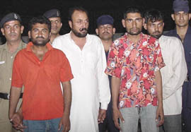All four accused, who were arrested with two revolvers and two stolen cars in the custody of the police in the Sector 26 police station in Chandigarh on Monday.